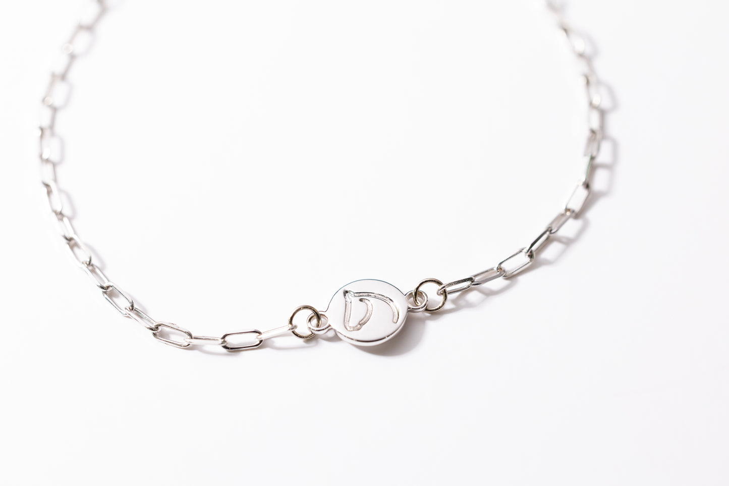 Silver bracelet with a clasp on a white background