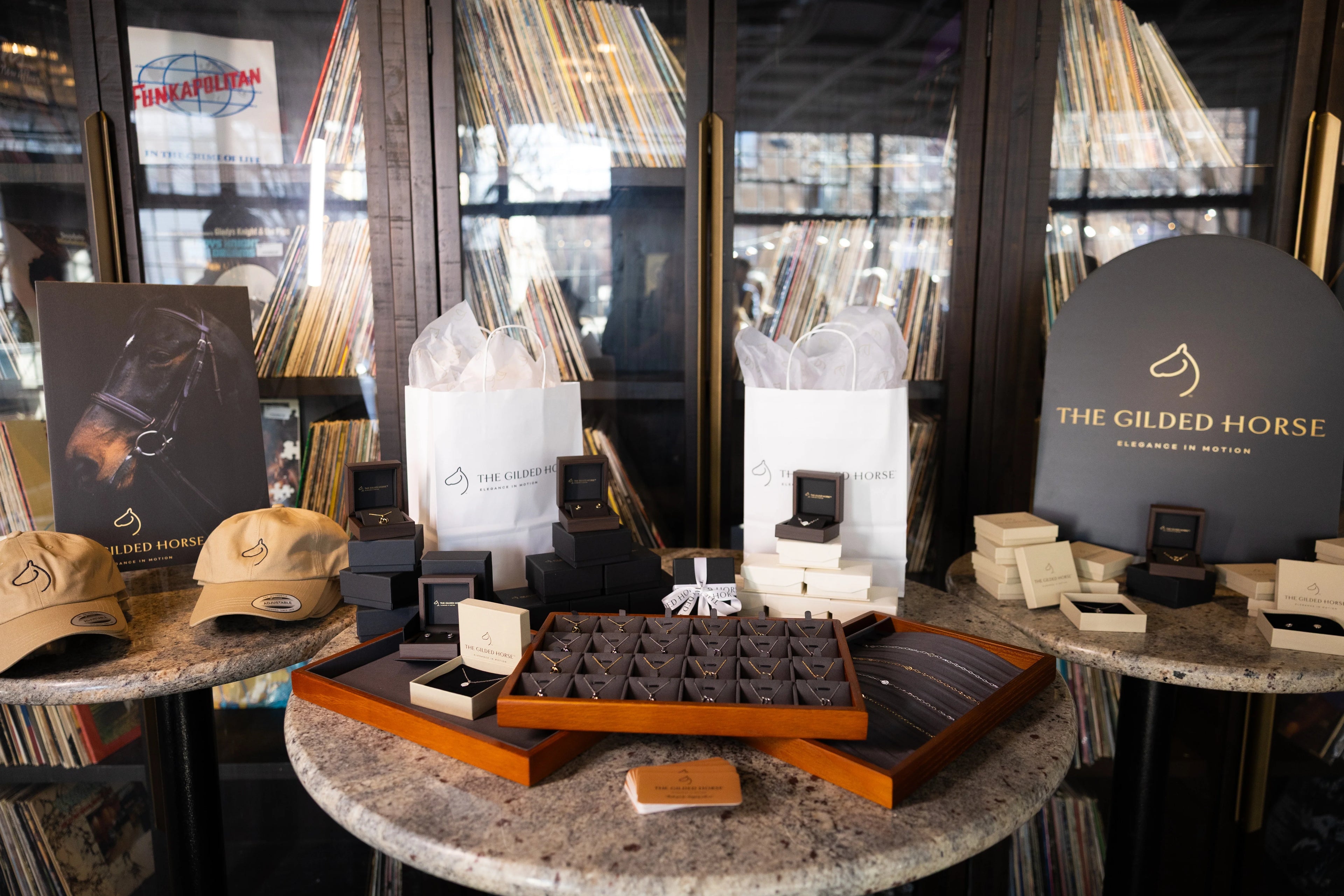 The Gilded Horse jewelry showroom display with cases of horse jewelry and a branded sign
