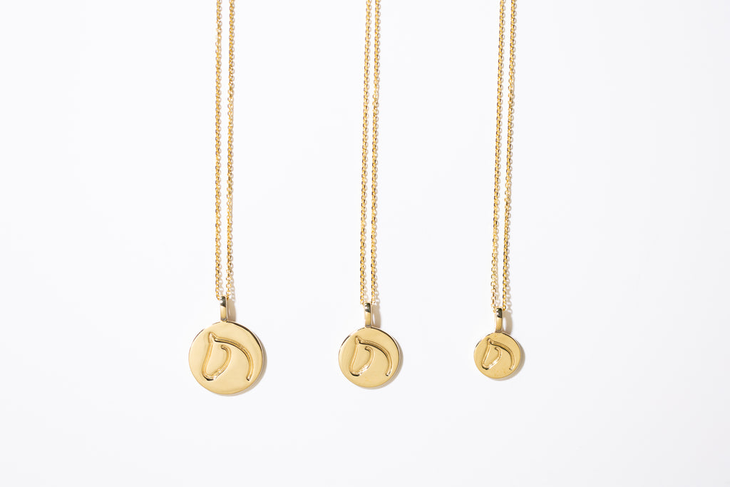 Three Gold Circle Medallion Pendant Necklaces from the The Gilded Horse (Large, Medium & Small) on a white background.