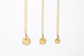 Three Gold Circle Medallion Pendant Necklaces from the The Gilded Horse (Large, Medium & Small) on a white background.