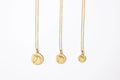 Three gold circle medallion horse necklaces in large, medium and small on white