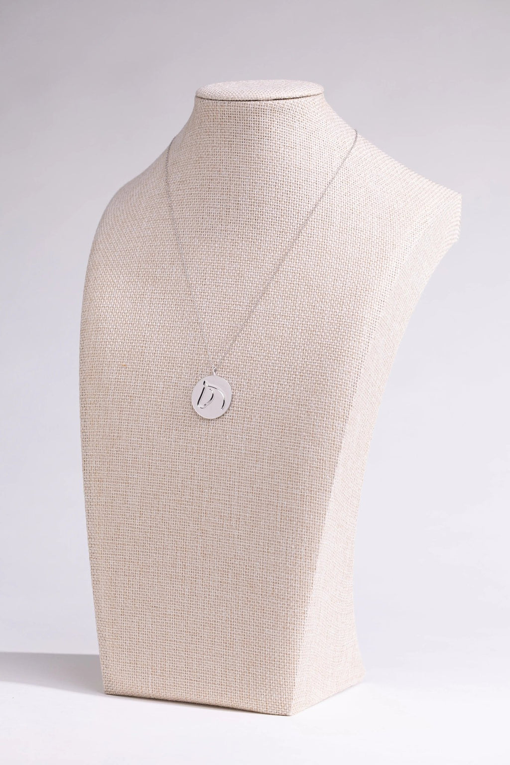 Sterling silver circle medallion horse necklace on a linen neck-form display