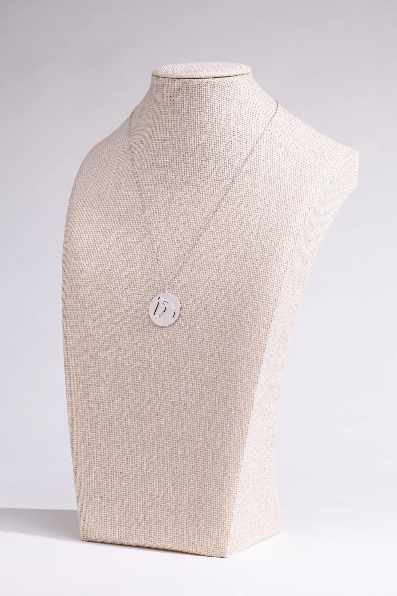 Sterling silver circle medallion horse necklace on a linen neck-form display