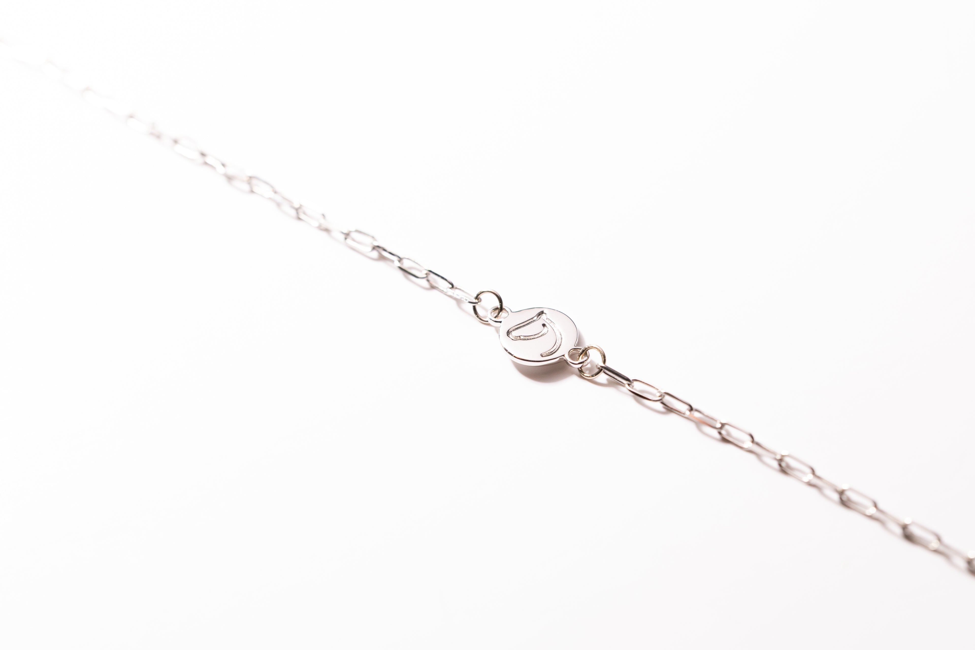 Silver bracelet on a white background.