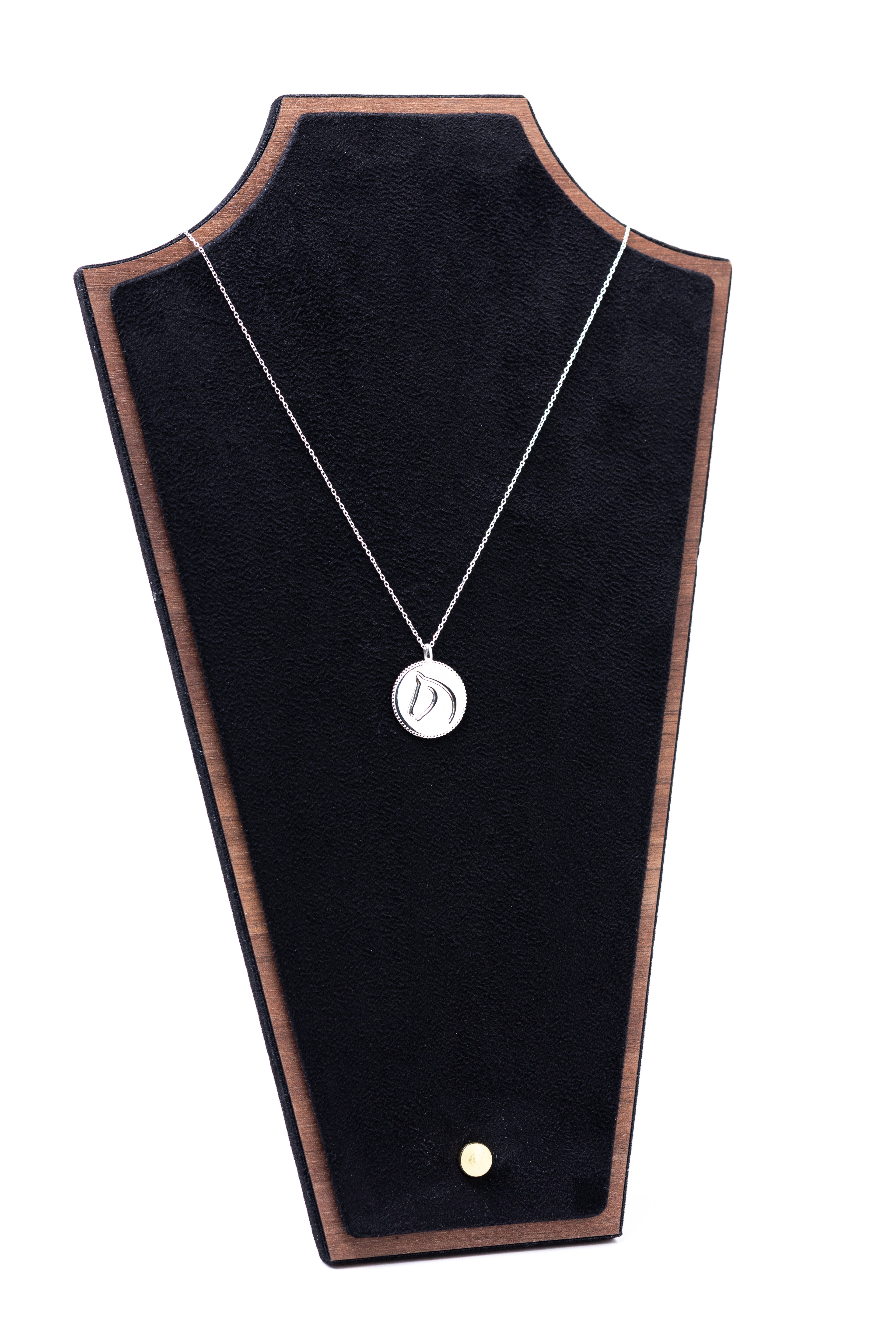 Necklace with a pendant on a black jewelry display