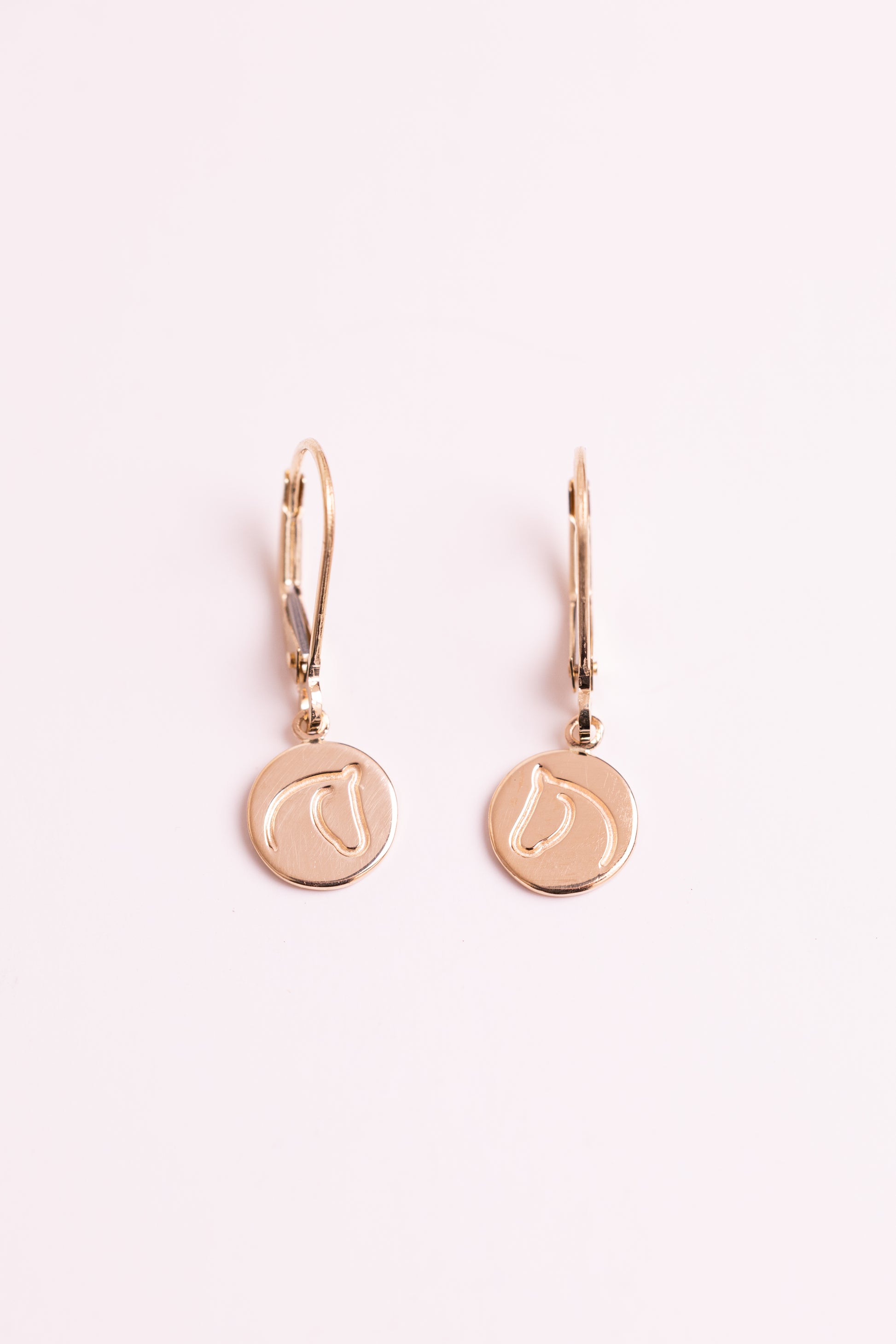 Gold earrings with The Gilded Horse logo with a white background.