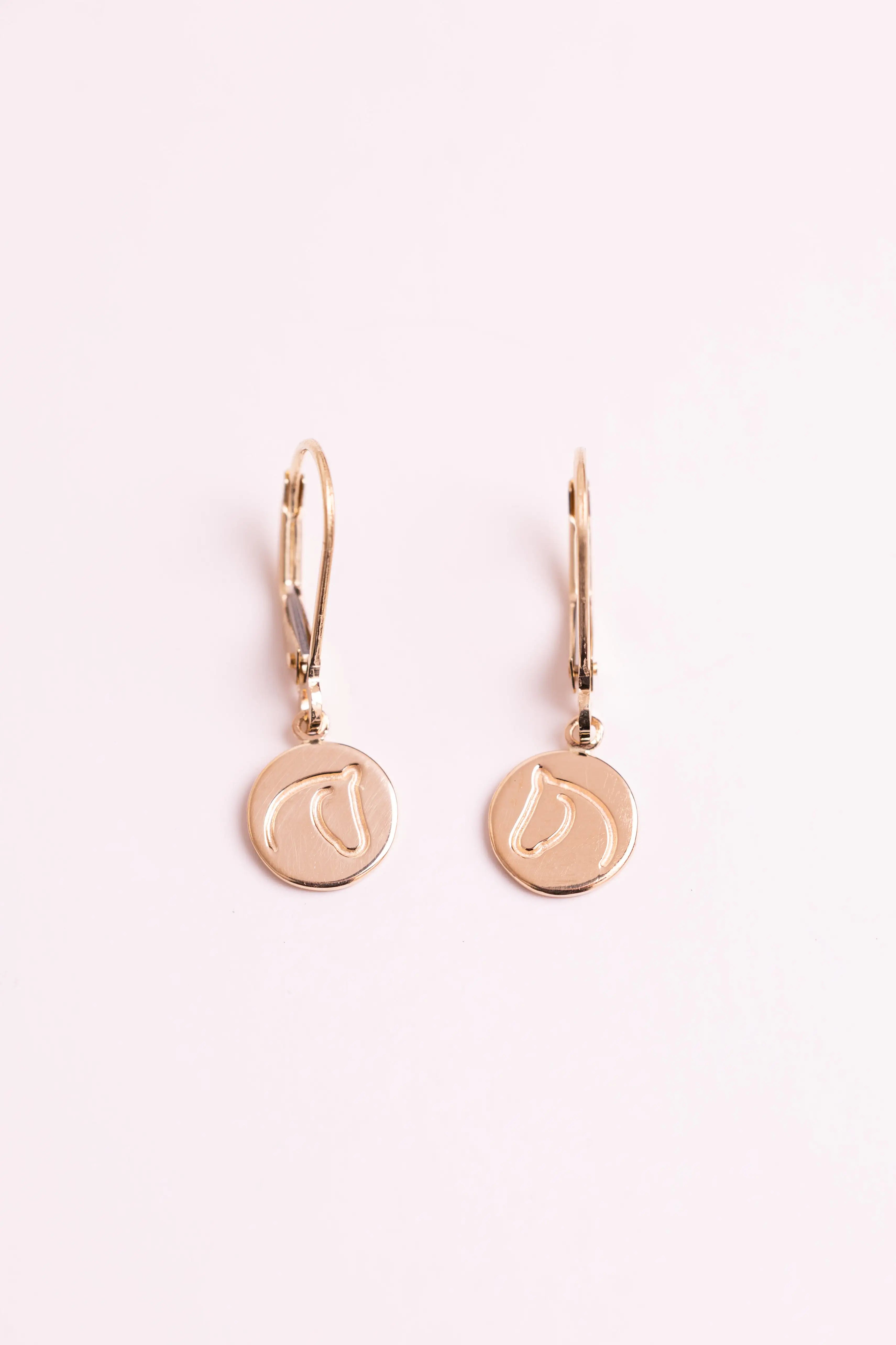 Gold earrings with The Gilded Horse logo with a white background.