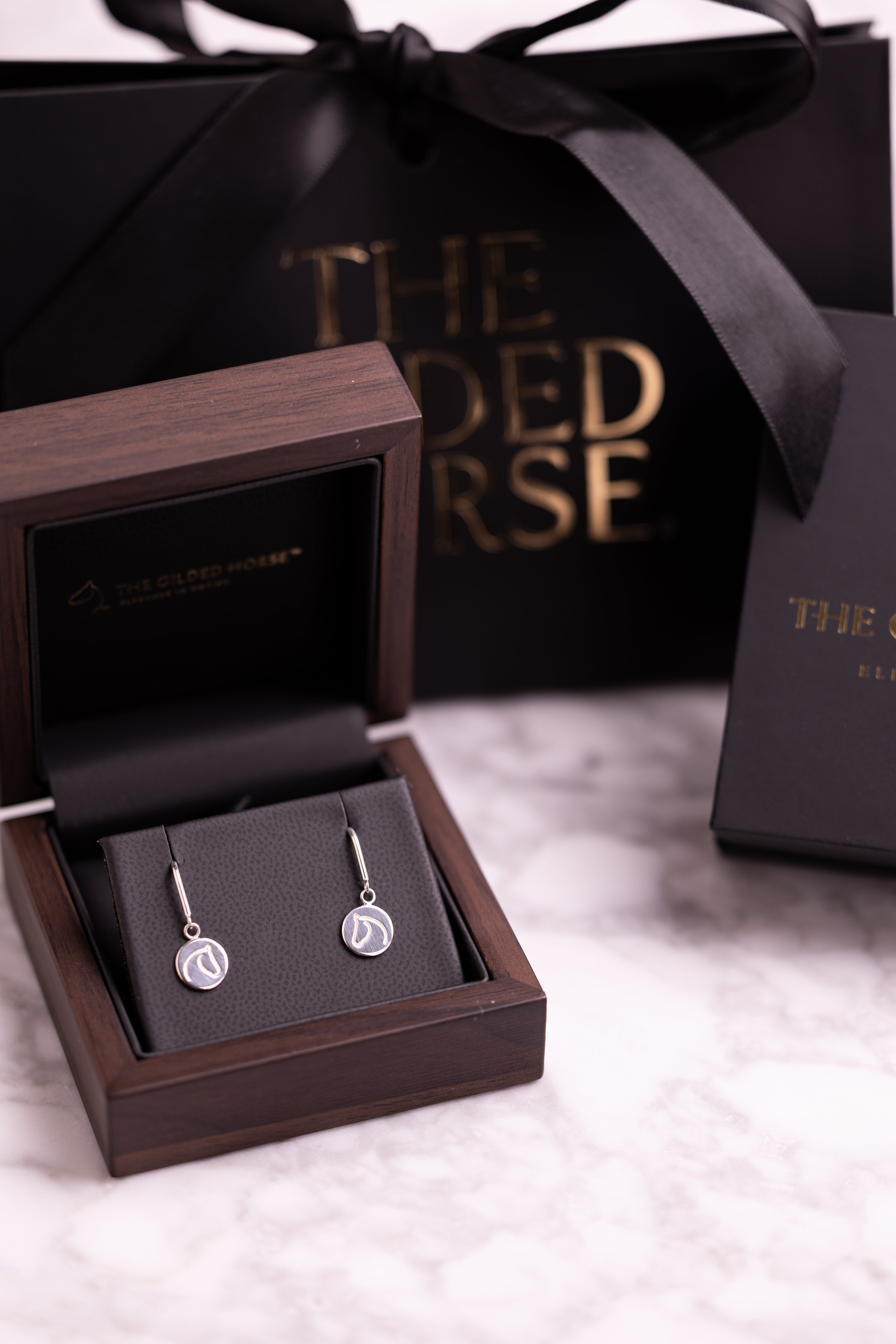 Sterling silver earrings with The Gilded Horse logo, in a nice jewelry box with packaging.