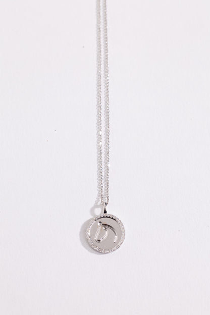 White gold and diamond necklace with a round pendant on a white background.