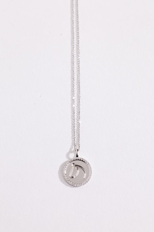 White gold and diamond necklace with a round pendant on a white background.