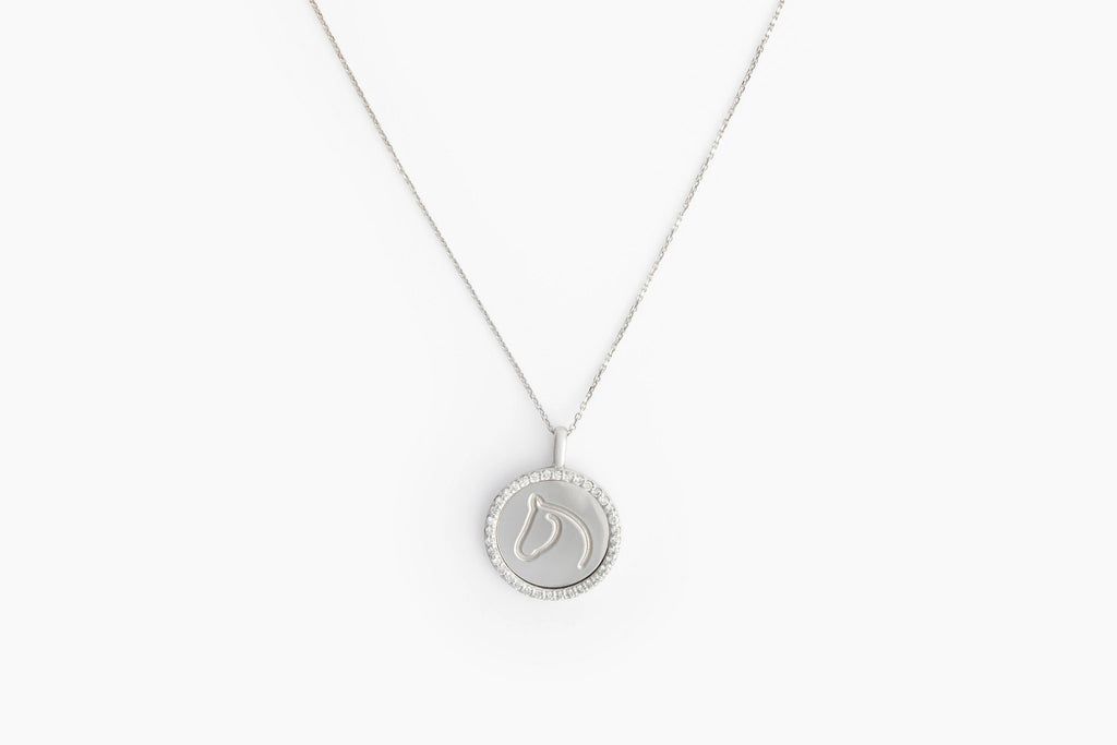 White gold diamond-border medallion with engraved horse-head, on slim chain