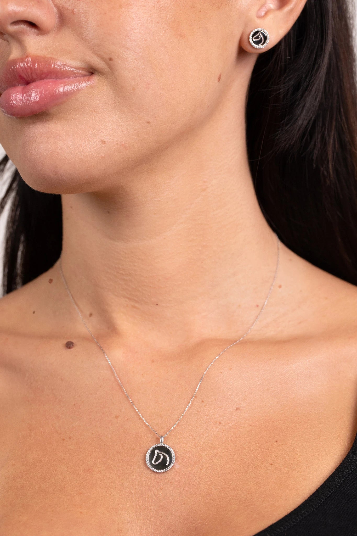 Woman wearing The Gilded Horse silver diamond medallion necklace and matching studs