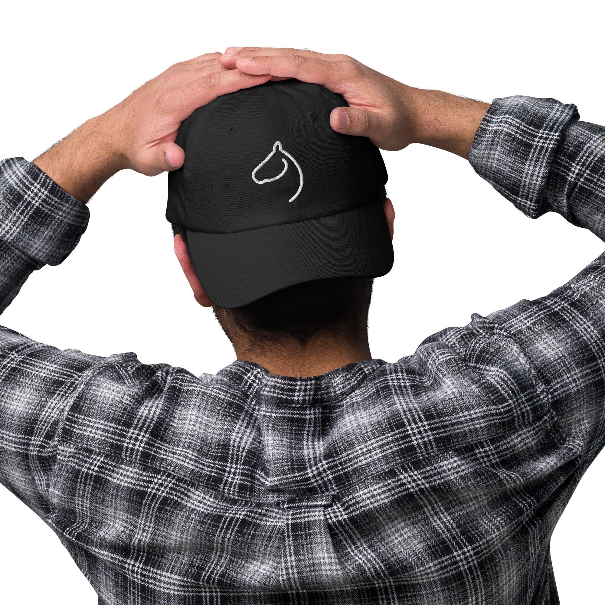 Man seen from behind adjusting a black The Gilded Horse cap with white horse-head logo