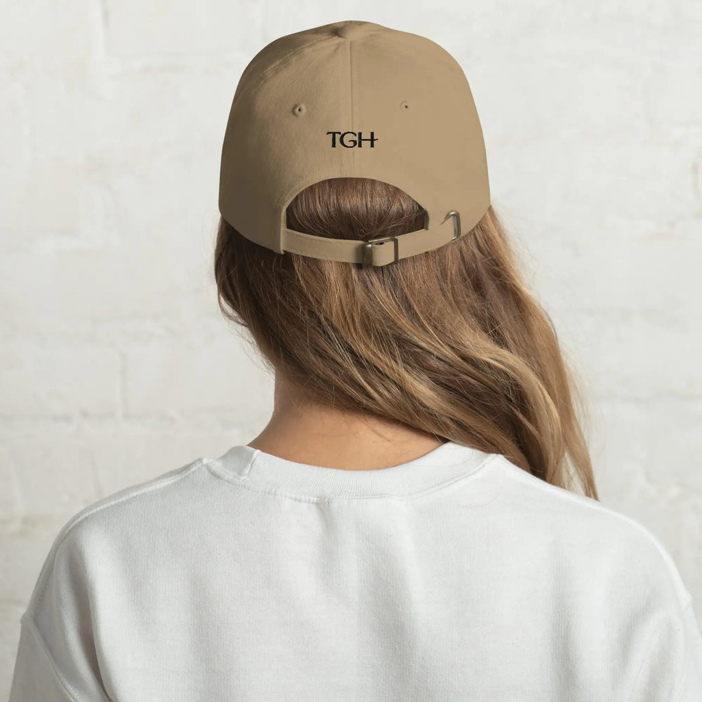 Back of The Gilded Horse khaki dad hat on a woman, black TGH embroidery