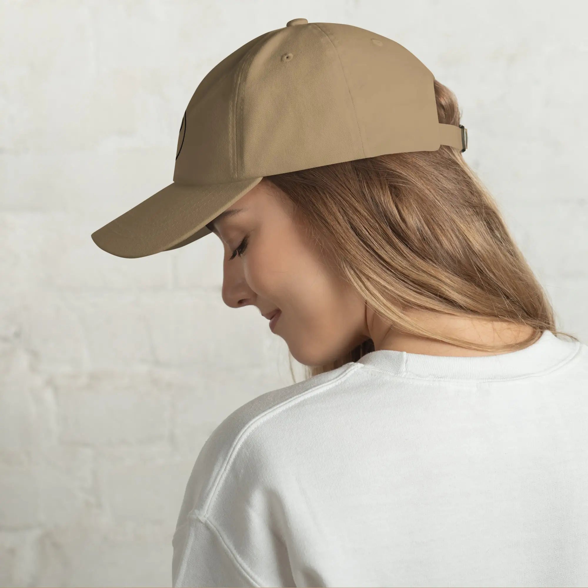 Woman wearing The Gilded Horse khaki dad hat, side profile view