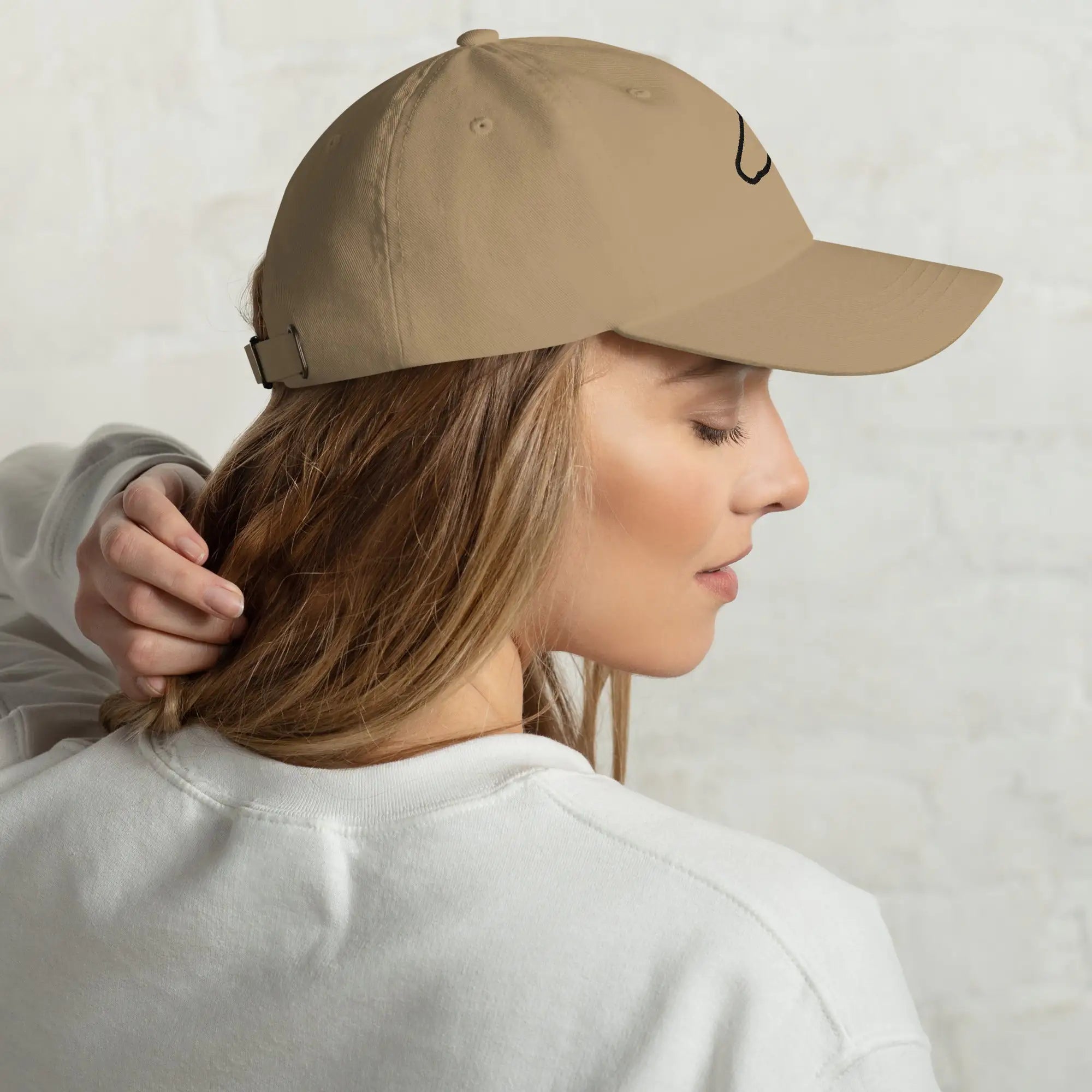Side view of The Gilded Horse khaki dad hat worn by a woman