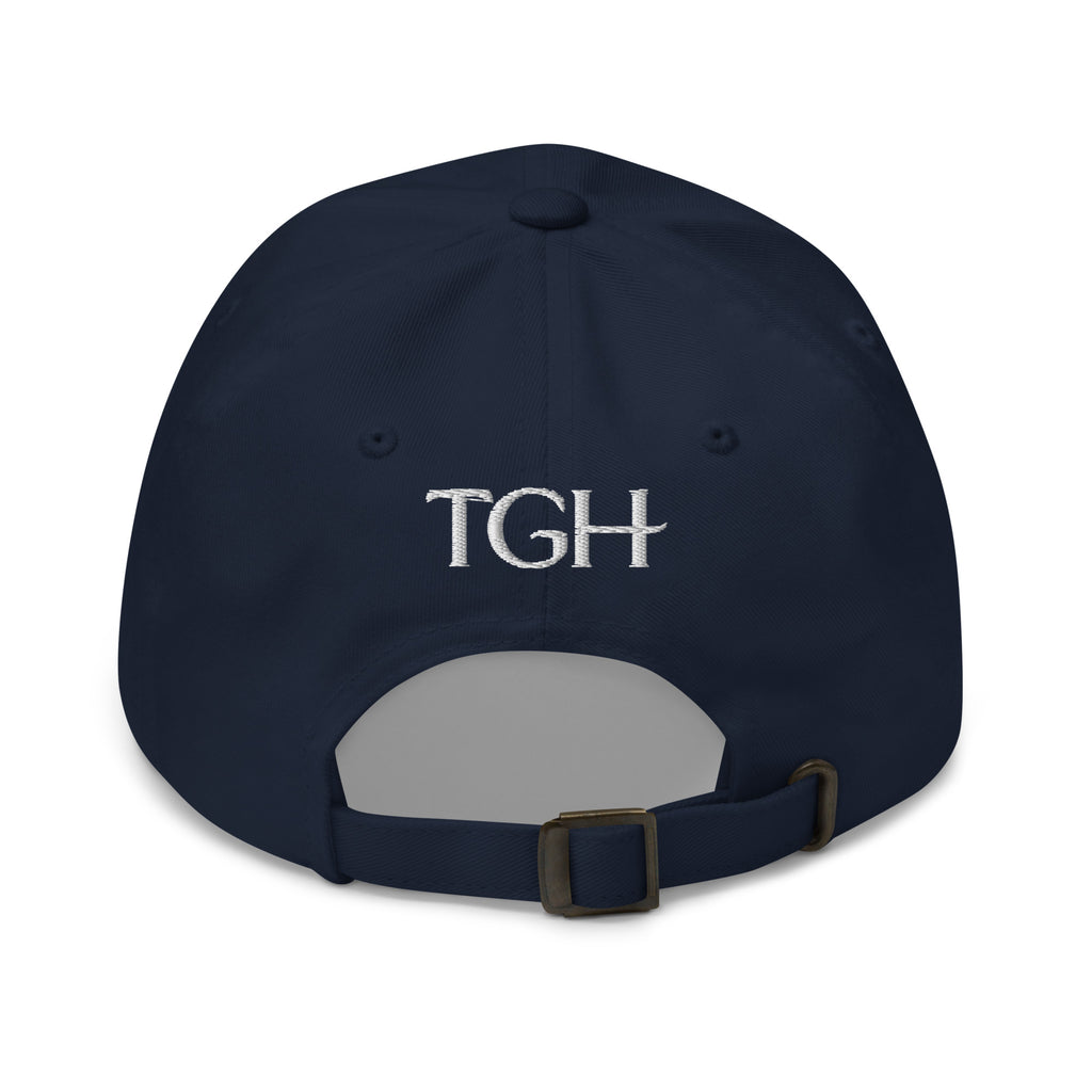 Back of a navy dad hat with "TGH" embroidered in white and an adjustable strap