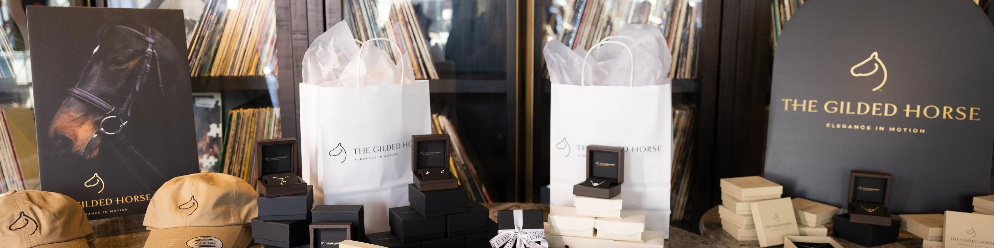 The Gilded Horse pop-up display with branded gift bags, jewelry boxes and a cap