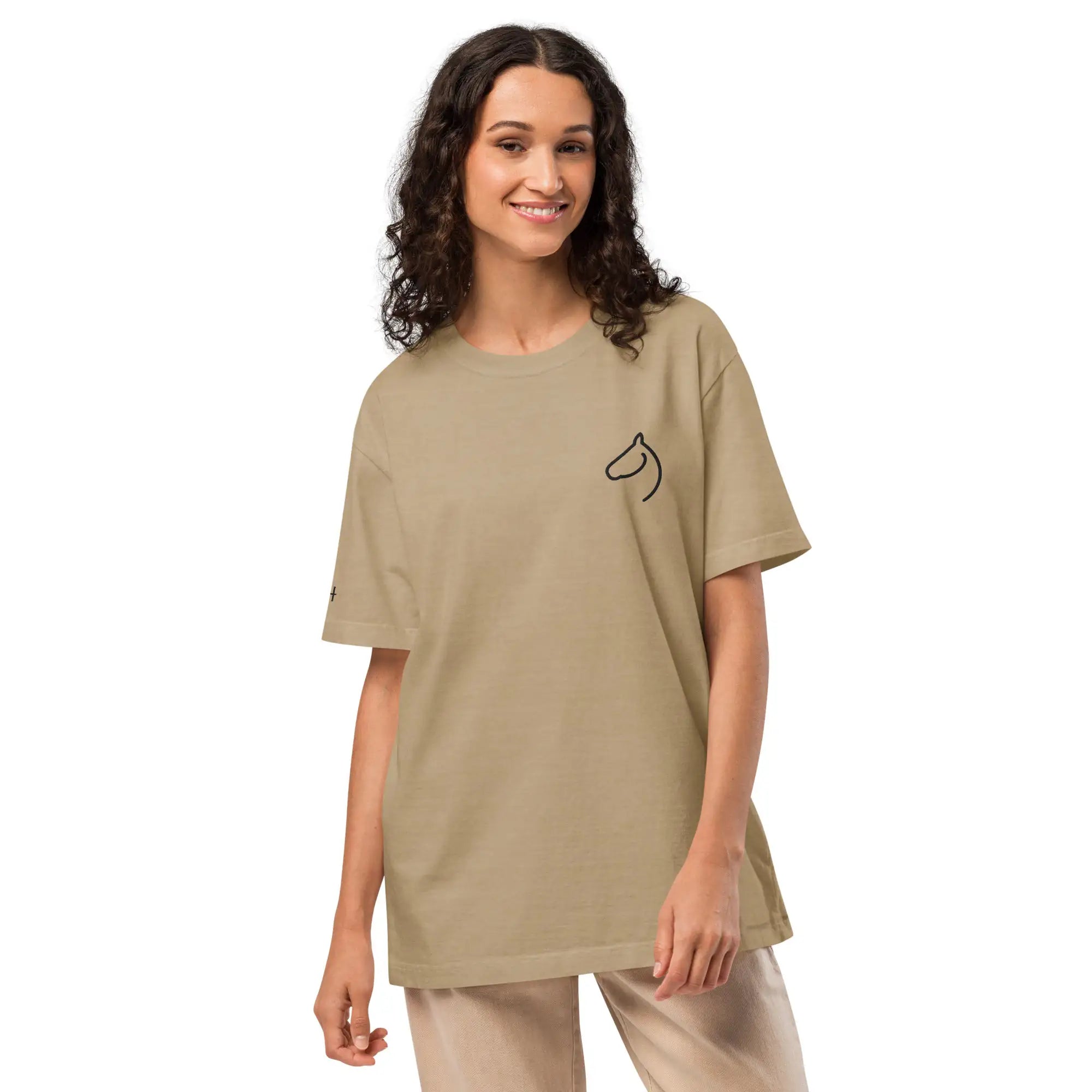 Woman in The Gilded Horse sand oversized tee with embroidered horse-head logo